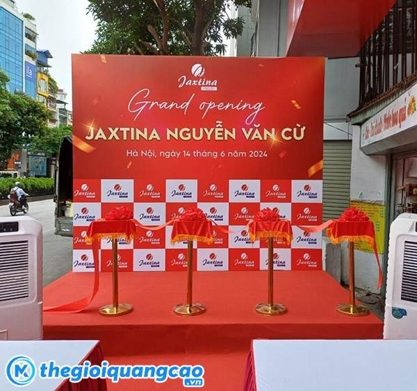 Mẫu backdrop grand opening Jaxtina Nguyễn Văn Cừ