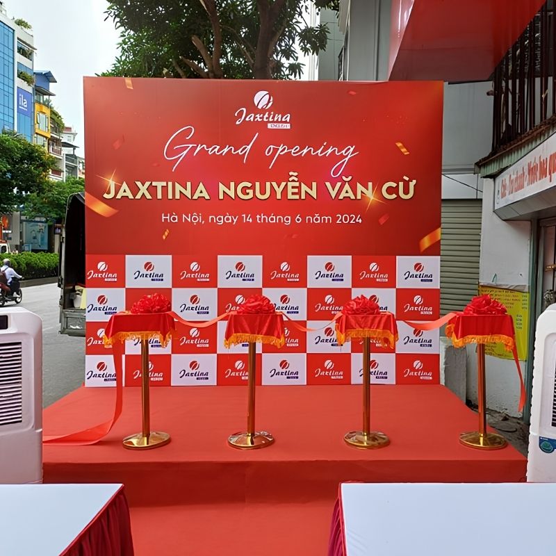 Mẫu backdrop khai trương Jaxtina Nguyễn Văn Cừ