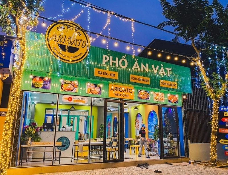 Mẫu bảng hiệu qu&aacute;n ăn vặt nền t&ocirc;n s&oacute;ng sơn m&agrave;u xanh l&aacute;